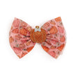 Every little girl needs the perfect hair clip to complete her look! The Pumpkin Daisy Blush Tulle Bow Clip is the perfect hair accessory for celebrating Fall. Features: * Pumpkin daisy printed tulle bow with gold glitter pin dot accents * Ribbon-covered alligator clip to grip the hair * Glitter accents are 