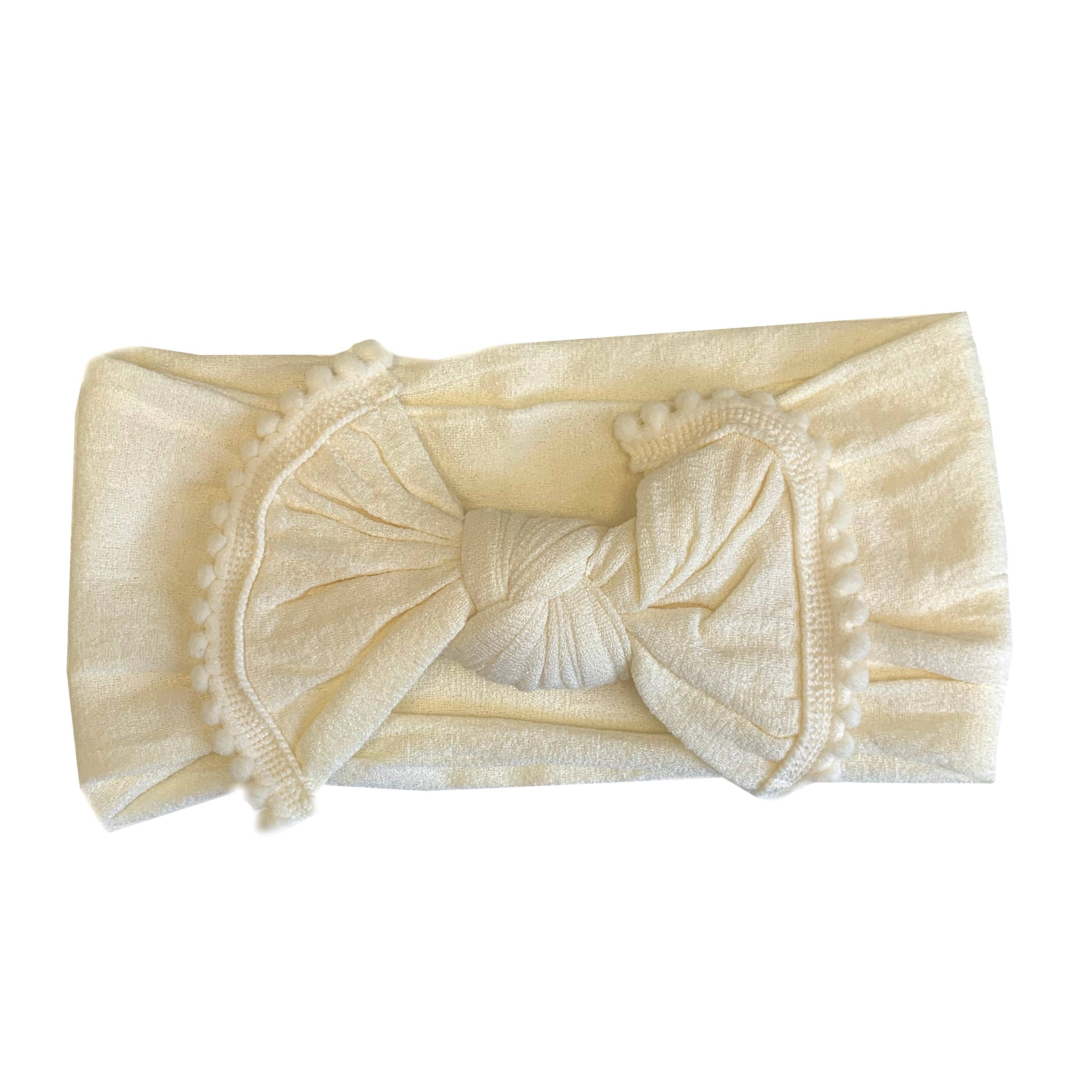 The softest baby headbands ever! Pair these adorable accessories with onesies, dresses, bloomers, and gowns for the cutest girl outfits. Color/Print: Cream Fabric: Nylon Sizing: Size 1 (0-12M) Fit: Stretchy Wash: Hand wash / Lay flat to dry Imported