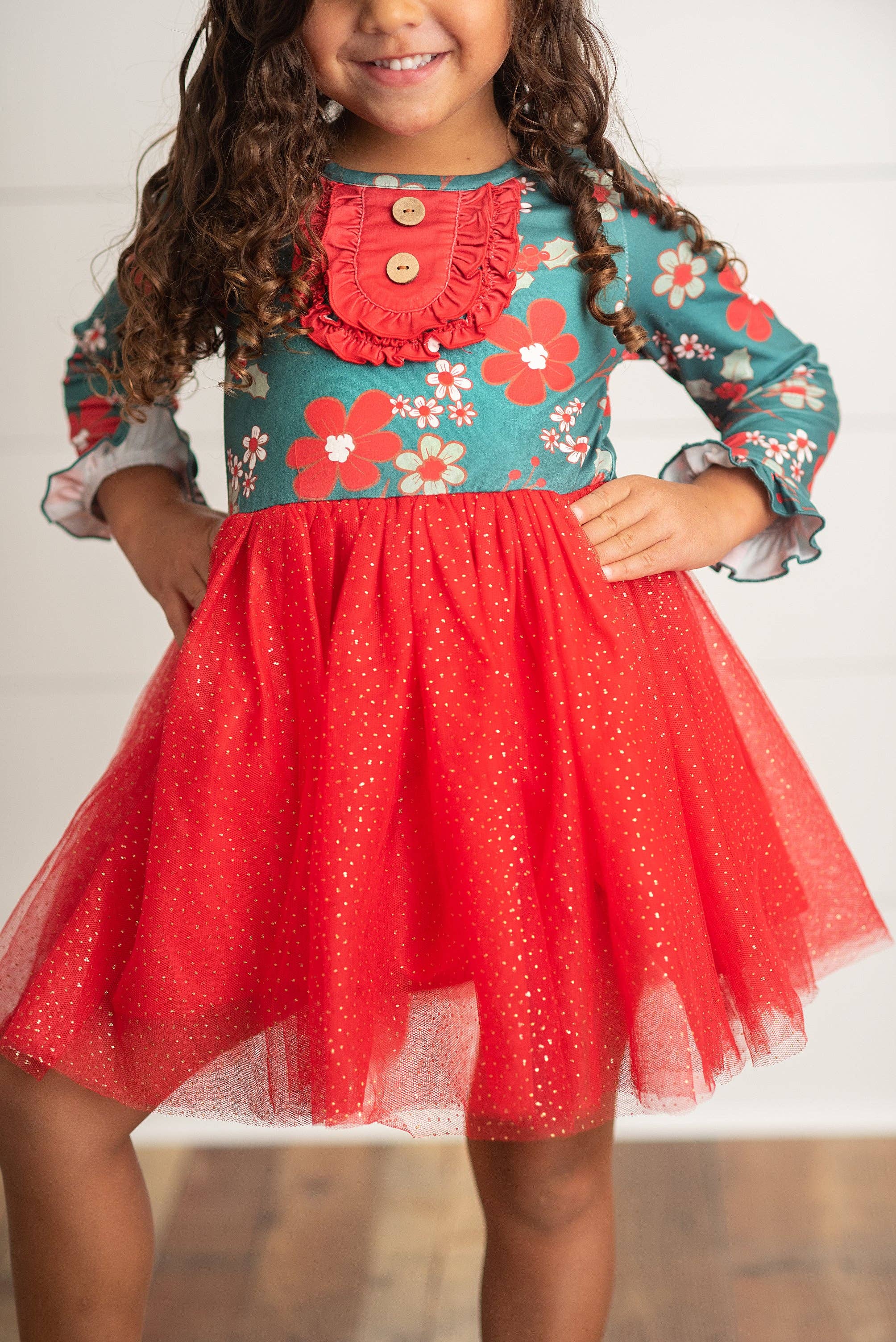 Girls green & red Christmas flowers ruffle button gold sparkley tulle dress is sure to be a favorite this Holiday season! Body: 95% Polyester, 5% Spandex Tulle: 100% Polyester