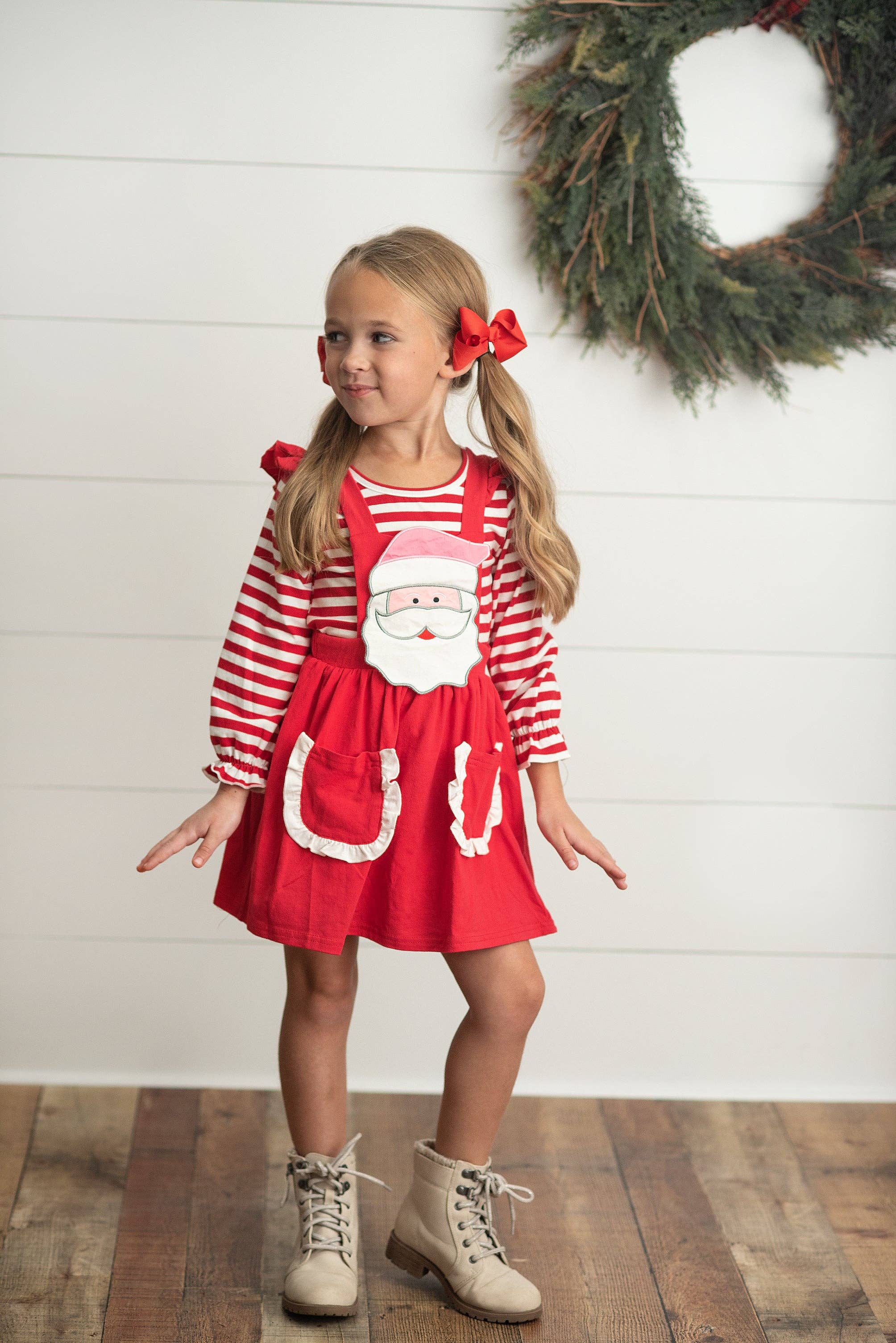 Girls two piece set includes red & white striped long sleeve ruffle shirt with Red ruffle pinafore jumper skirt. Ruffle pockets and large applique Santa on front make this the cutest Christmas Holiday set! 97% Cotton, 3% Spandex